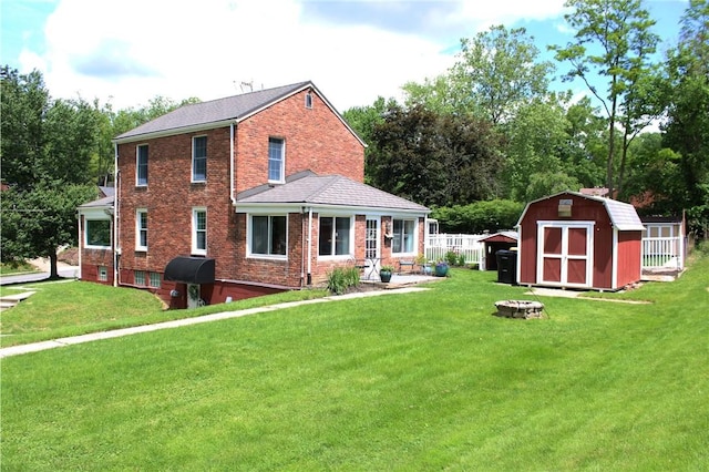 5827 Kings School Rd, Bethel Park, PA 15102 - back of house featuring an outdoor fire pit, brick siding, and a yard