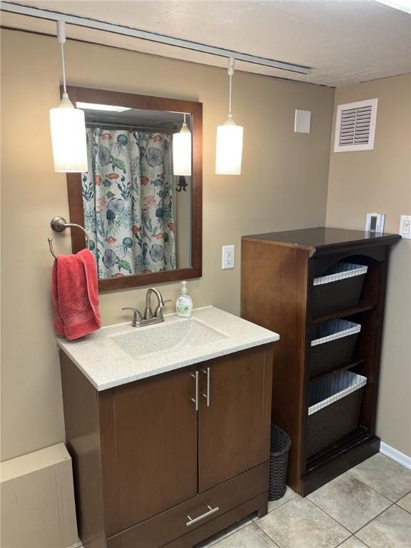 5827 Kings School Rd, Bethel Park, PA 15102 - bathroom with vanity, tile patterned flooring, and baseboards