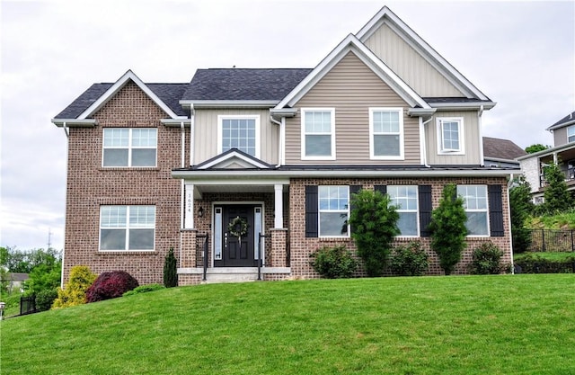 1624 Windsor Rd, North Huntingdon, PA 15642 - craftsman-style house with board and batten siding, a front yard, and brick siding