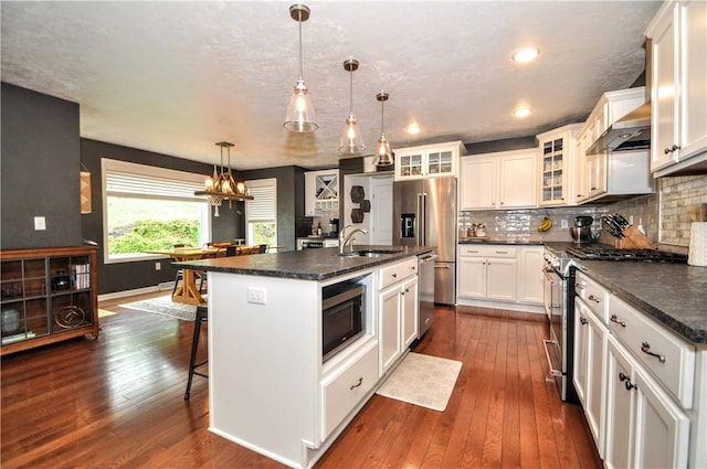 1624 Windsor Rd, North Huntingdon, PA 15642 - kitchen featuring appliances with stainless steel finishes, a sink, dark countertops, dark wood-type flooring, and recessed lighting