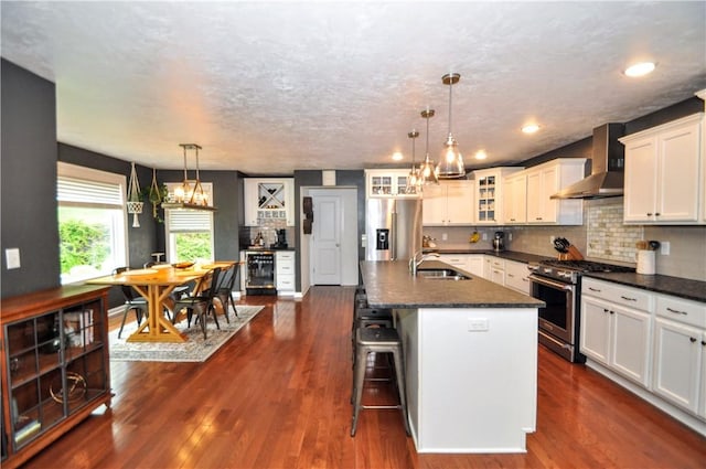 1624 Windsor Rd, North Huntingdon, PA 15642 - kitchen featuring high quality appliances, wall chimney range hood, a sink, glass insert cabinets, and backsplash