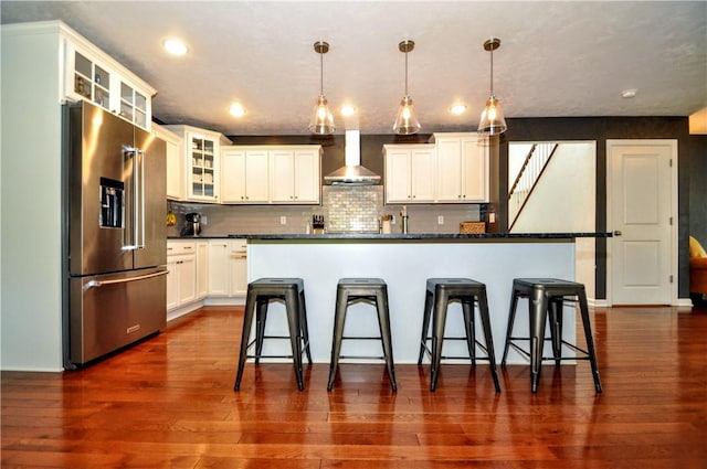 1624 Windsor Rd, North Huntingdon, PA 15642 - kitchen with high end fridge, wall chimney exhaust hood, dark countertops, a breakfast bar, and recessed lighting
