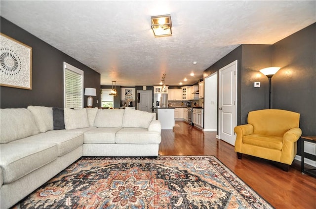 1624 Windsor Rd, North Huntingdon, PA 15642 - living area with dark wood finished floors, baseboards, and a textured ceiling