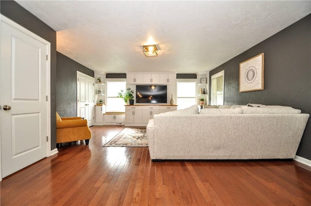 1624 Windsor Rd, North Huntingdon, PA 15642 - living room featuring dark wood-type flooring, healthy amount of natural light, and baseboards