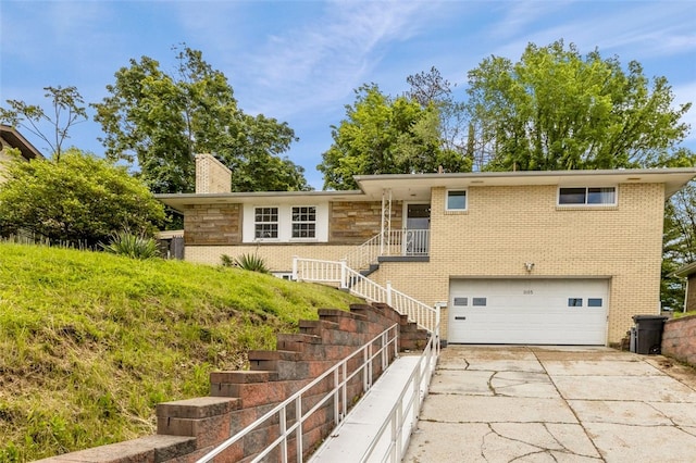 1105 Greentree Rd, Green Tree, PA 15220 - single story home with an attached garage, concrete driveway, a chimney, brick siding, and stairway