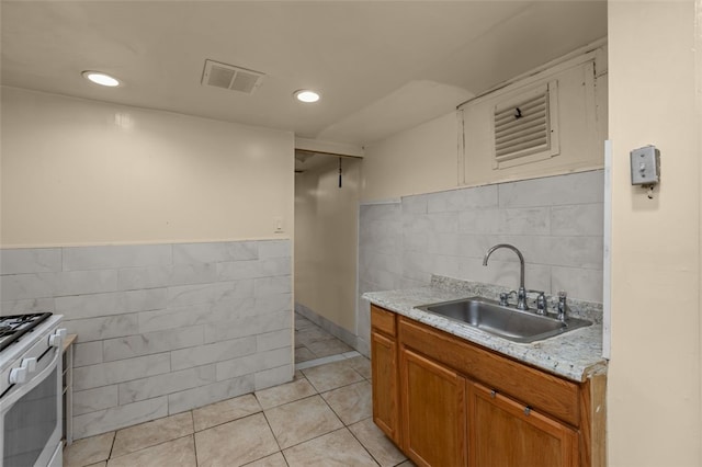 1105 Greentree Rd, Green Tree, PA 15220 - kitchen with a sink, tile walls, gas range gas stove, light tile patterned floors, and brown cabinets