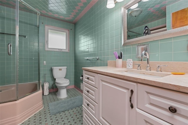 1105 Greentree Rd, Green Tree, PA 15220 - bathroom with tile walls, vanity, toilet, bath / shower combo with glass door, and tile patterned flooring
