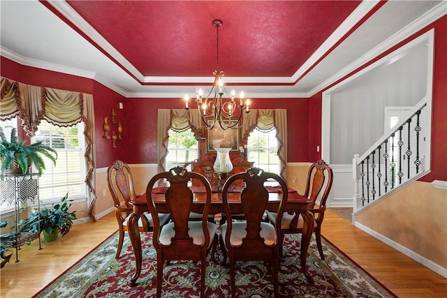 5121 Forest Ridge Dr, South Fayette, PA 15057 - dining space with a raised ceiling, a chandelier, healthy amount of natural light, wainscoting, and crown molding