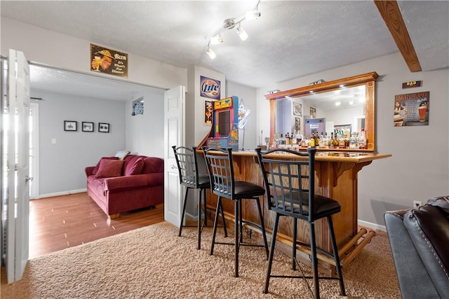 5121 Forest Ridge Dr, South Fayette, PA 15057 - indoor dry bar featuring baseboards, wood finished floors, and a textured ceiling