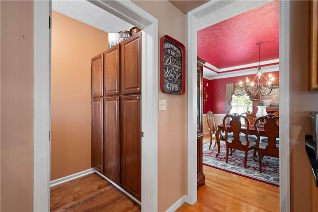 5121 Forest Ridge Dr, South Fayette, PA 15057 - hallway with light wood-style floors, a chandelier, and baseboards