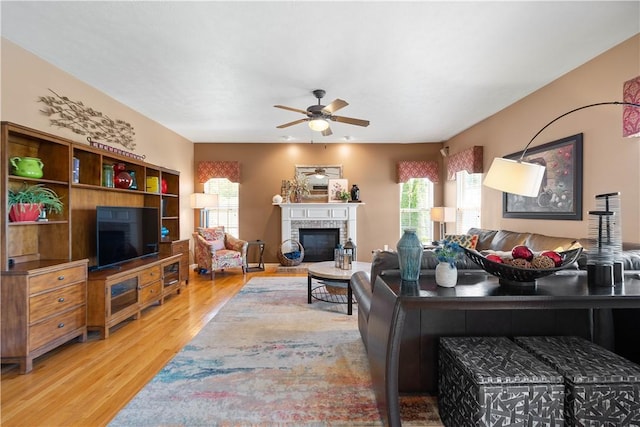 5121 Forest Ridge Dr, South Fayette, PA 15057 - living area featuring wood finished floors, ceiling fan, healthy amount of natural light, and a glass covered fireplace