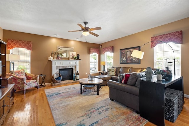 5121 Forest Ridge Dr, South Fayette, PA 15057 - living room featuring ceiling fan, hardwood / wood-style floors, a brick fireplace, and baseboards