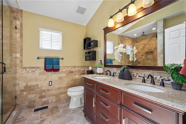 5121 Forest Ridge Dr, South Fayette, PA 15057 - bathroom featuring tile walls, plenty of natural light, a stall shower, double vanity, and toilet