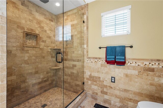 5121 Forest Ridge Dr, South Fayette, PA 15057 - full bath with a stall shower, healthy amount of natural light, tile walls, toilet, and a wainscoted wall