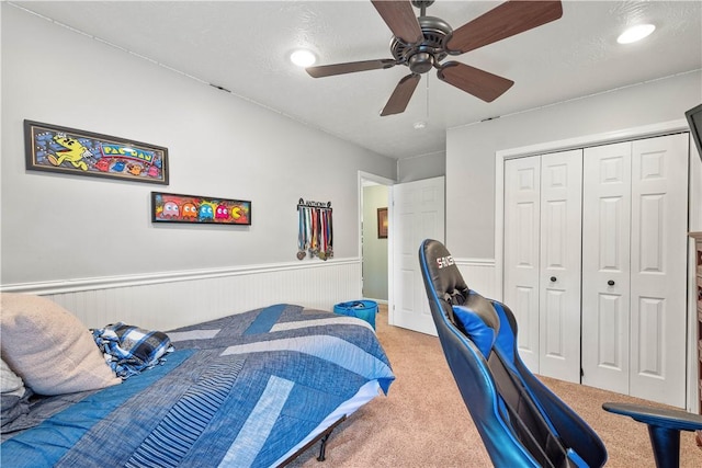 5121 Forest Ridge Dr, South Fayette, PA 15057 - bedroom featuring a wainscoted wall, light carpet, a closet, and a ceiling fan