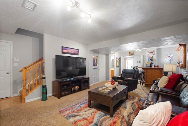 5121 Forest Ridge Dr, South Fayette, PA 15057 - carpeted living room featuring a textured ceiling, stairs, and baseboards