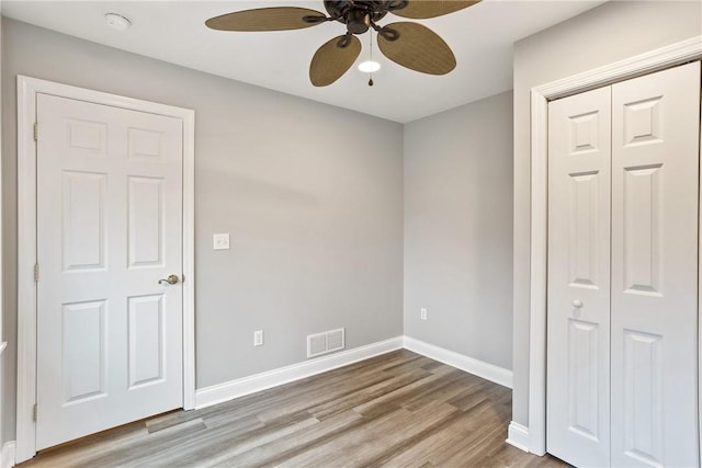 19 Telescope St, South Side, PA 15203 - unfurnished bedroom with light wood-style flooring, baseboards, ceiling fan, and a closet