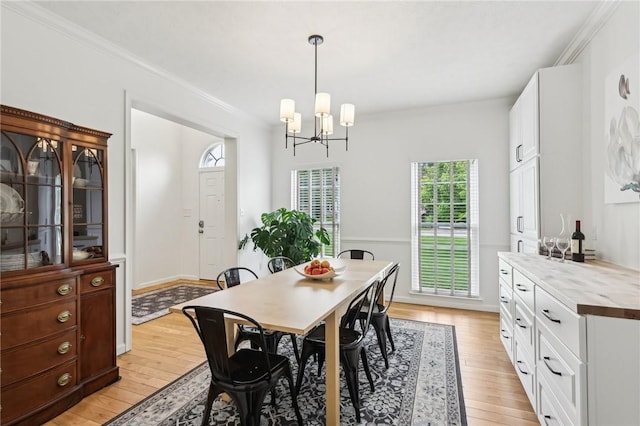 319 Buffalo Ridge Rd, Peters Twp, PA 15317 - dining room with light wood-type flooring, a chandelier, and crown molding