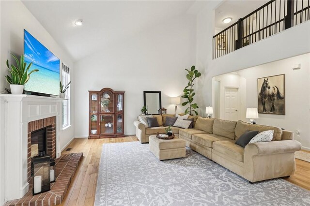 319 Buffalo Ridge Rd, Peters Twp, PA 15317 - living room featuring high vaulted ceiling, wood finished floors, baseboards, and a brick fireplace