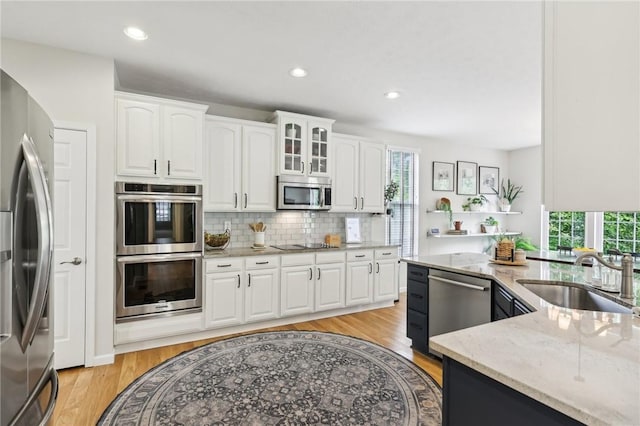 319 Buffalo Ridge Rd, Peters Twp, PA 15317 - kitchen featuring appliances with stainless steel finishes, a sink, healthy amount of natural light, light stone countertops, and recessed lighting