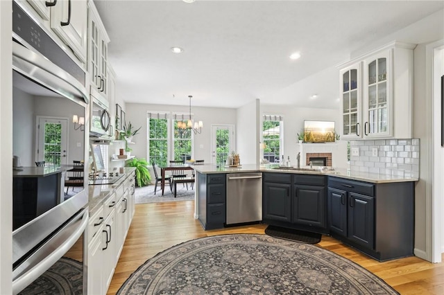 319 Buffalo Ridge Rd, Peters Twp, PA 15317 - kitchen featuring appliances with stainless steel finishes, white cabinets, light wood-type flooring, plenty of natural light, and recessed lighting