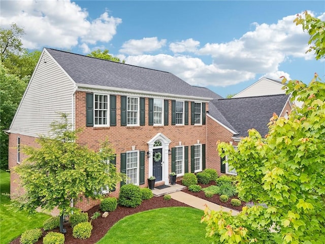 319 Buffalo Ridge Rd, Peters Twp, PA 15317 - colonial-style house with brick siding, a front lawn, and roof with shingles