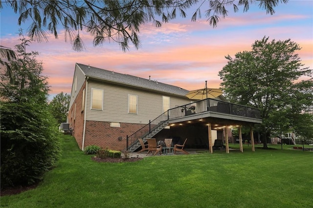 319 Buffalo Ridge Rd, Peters Twp, PA 15317 - back of property at dusk featuring stairs, a deck, and brick siding