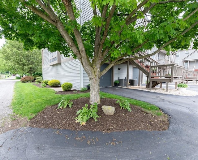 1099 Riverside Dr Unit H, Bridgewater, PA 15009 - view of property hidden behind natural elements featuring driveway, cooling unit, and an attached garage