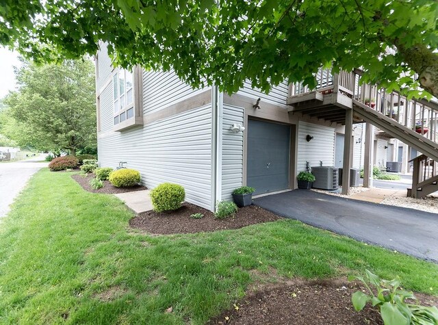 1099 Riverside Dr Unit H, Bridgewater, PA 15009 - view of side of home with central AC, a lawn, asphalt driveway, and an attached garage