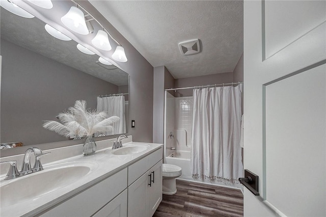 8 Pony Ct, Findlay Twp, PA 15126 - full bathroom featuring toilet, double vanity, shower / tub combo, wood finished floors, and a textured ceiling