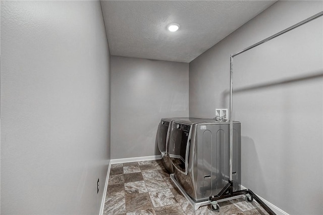 8 Pony Ct, Findlay Twp, PA 15126 - laundry room with washer and dryer, baseboards, a textured ceiling, and stone finish floors