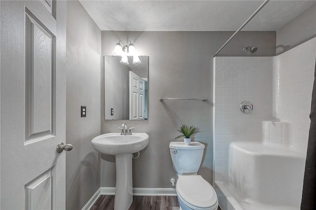 8 Pony Ct, Findlay Twp, PA 15126 - bathroom featuring a shower, toilet, baseboards, wood finished floors, and a textured ceiling