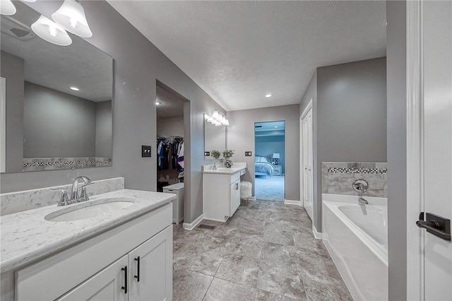 8 Pony Ct, Findlay Twp, PA 15126 - full bath featuring two vanities, a garden tub, baseboards, and a textured ceiling