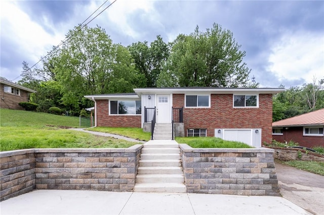 5 Albert St, South Union Twp, PA 15401 - view of front of home featuring brick siding, an attached garage, and a front lawn