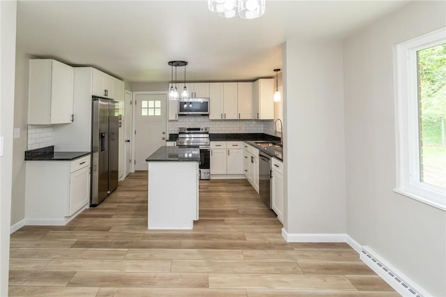 5 Albert St, South Union Twp, PA 15401 - kitchen featuring appliances with stainless steel finishes, baseboard heating, dark countertops, and backsplash
