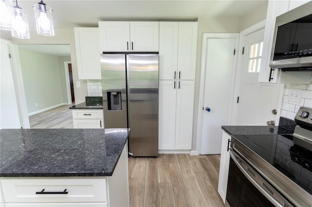 5 Albert St, South Union Twp, PA 15401 - kitchen featuring appliances with stainless steel finishes, light wood-style floors, tasteful backsplash, dark stone countertops, and white cabinetry