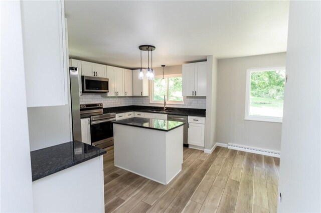 5 Albert St, South Union Twp, PA 15401 - kitchen with appliances with stainless steel finishes, a baseboard radiator, tasteful backsplash, and light wood-type flooring