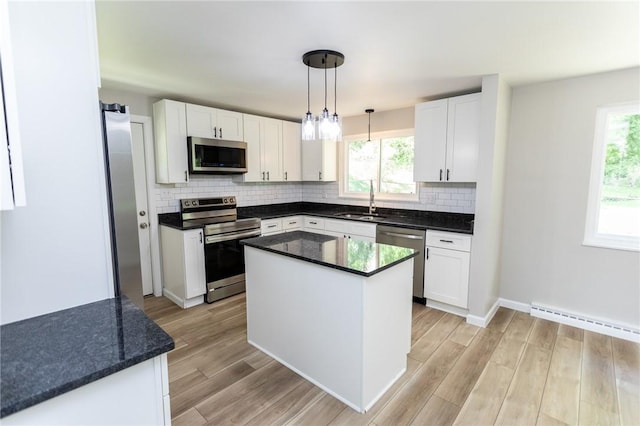 5 Albert St, South Union Twp, PA 15401 - kitchen with stainless steel appliances, a baseboard radiator, tasteful backsplash, and white cabinetry