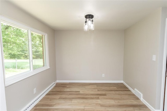 5 Albert St, South Union Twp, PA 15401 - spare room featuring a baseboard heating unit, healthy amount of natural light, and light wood-style flooring