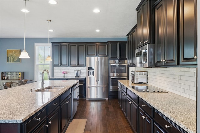 1340 Diamond Ct, Upper St Clair, PA 15241 - kitchen featuring stainless steel appliances, a sink, dark wood-style flooring, backsplash, and decorative light fixtures