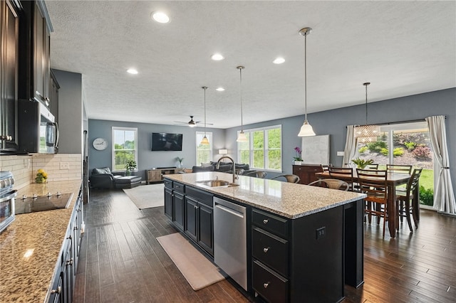 1340 Diamond Ct, Upper St Clair, PA 15241 - kitchen with open floor plan, appliances with stainless steel finishes, a sink, dark cabinets, and recessed lighting