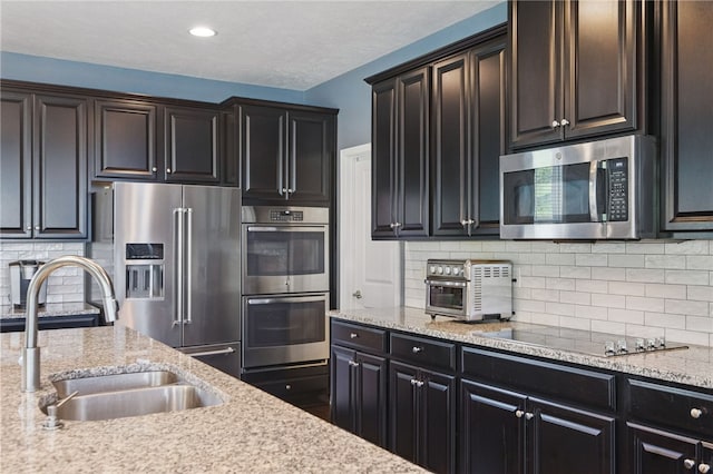 1340 Diamond Ct, Upper St Clair, PA 15241 - kitchen featuring stainless steel appliances, a sink, backsplash, light stone counters, and recessed lighting