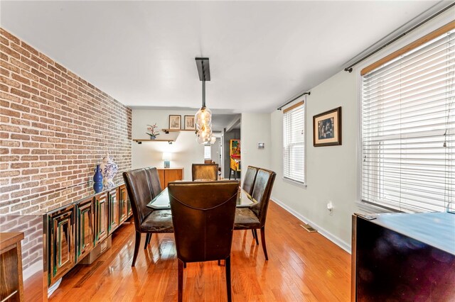 1816 Jane, South Side, PA 15203 - dining area featuring brick wall, light wood-style floors, and baseboards