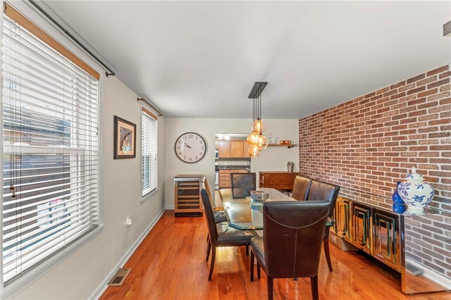 1816 Jane, South Side, PA 15203 - dining room with brick wall, light wood-style floors, beverage cooler, and baseboards