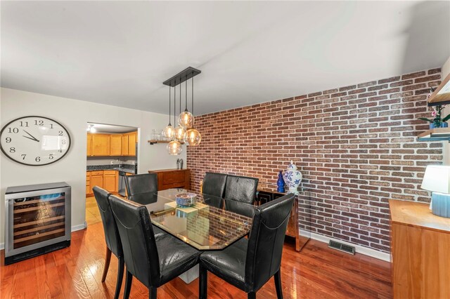 1816 Jane, South Side, PA 15203 - dining area with wine cooler, brick wall, wood finished floors, and baseboards