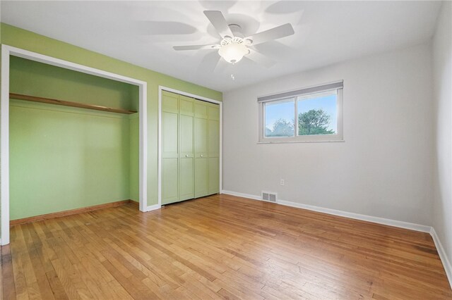306 Tadmar Ave, Ross Twp, PA 15237 - unfurnished bedroom with two closets, light wood-style floors, baseboards, and ceiling fan