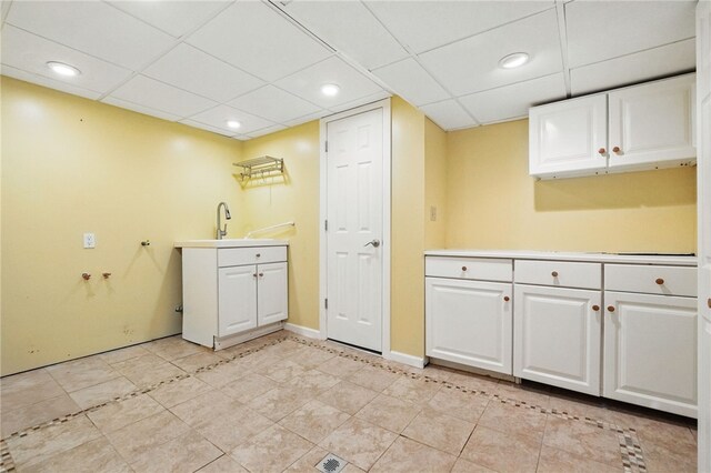 306 Tadmar Ave, Ross Twp, PA 15237 - kitchen with white cabinetry, a paneled ceiling, light countertops, a sink, and baseboards