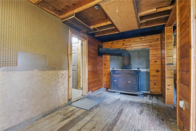 306 Tadmar Ave, Ross Twp, PA 15237 - unfurnished living room with a wood stove, hardwood / wood-style flooring, and wooden walls