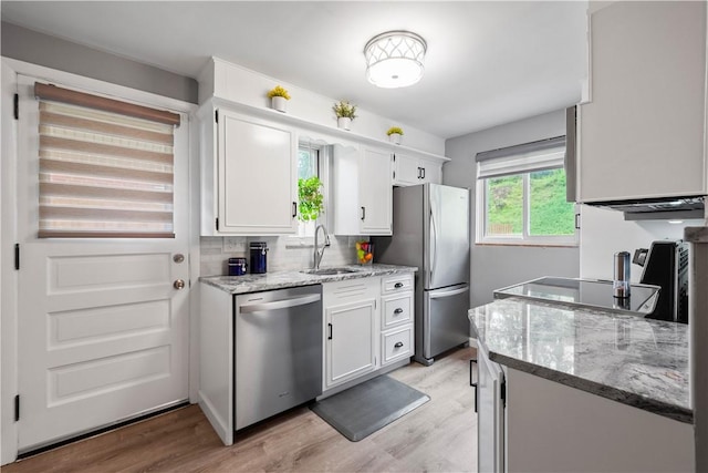 1137 Michael Dr, Baldwin Boro, PA 15227 - kitchen featuring stainless steel appliances, a sink, white cabinetry, light wood-style floors, and backsplash