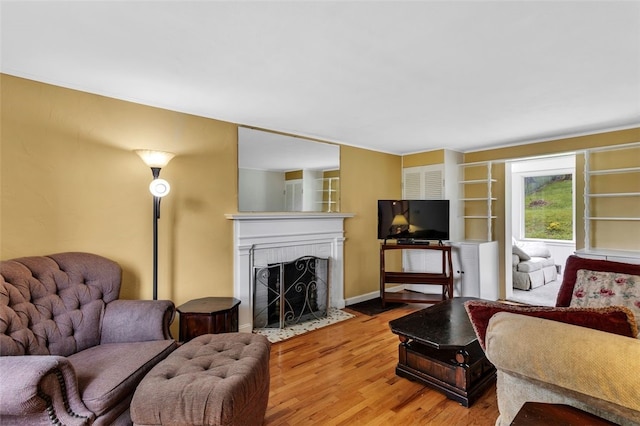 5352 Highgrove Rd, Whitehall, PA 15236 - living area featuring a fireplace with flush hearth and wood finished floors